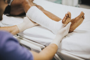 doctor-helping-patient-with-fractured-leg