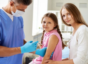 doctor-injecting-vaccine-little-girl_1098-378